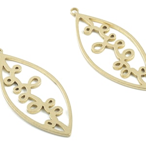 May include: Two gold-toned metal leaf-shaped charms with a delicate, intricate design. Each charm has a loop at the top for attaching to jewelry or other crafts.