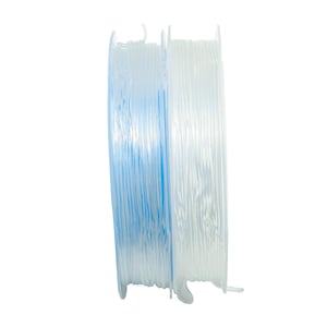 May include: Two spools of clear fishing line, one is a light blue color and the other is a clear white color.
