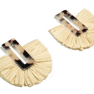 May include: A pair of cream-coloured tassel earrings with a tortoiseshell-patterned rectangular accent piece.