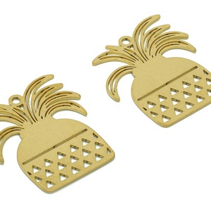 May include: Two gold-coloured pineapple-shaped metal charms with a cutout design. The charms have a hole at the top for hanging.
