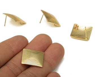 May include: Gold-toned metal earrings. The earrings have a square shape with a textured surface. Two earrings are post-style, and one is held in a hand. The earrings have a minimalist, geometric design.