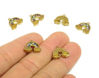 May include: Gold-coloured rainbow charms with colourful gemstone accents. The charms are in the shape of a rainbow, with a small loop at the top for attaching to jewellery. The charms are small and detailed.