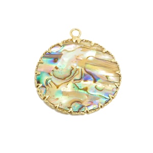 May include: A round, iridescent abalone shell pendant with a gold-toned metal frame and a scalloped edge. The pendant has a loop at the top for attaching to a chain or cord.