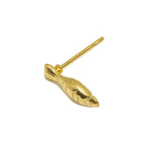 May include: A gold-colored fish-shaped stud earring. The earring is made of metal and has a simple design.