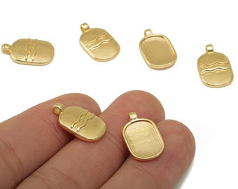 May include: Gold-colored rectangular pendant charms with a loop at the top. Some charms have a wavy design, while others are smooth. The charms are shown in a close-up shot.