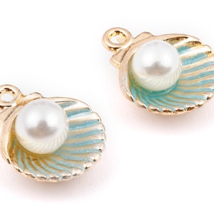 May include: Two gold-tone shell charms with a white pearl inside. The shells are blue and gold.