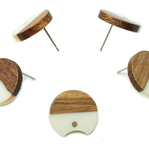 May include: Set of four wooden earrings with a half-circle design. Each earring is made of two different types of wood, one light and one dark, creating a unique pattern. The earrings are attached to silver posts.