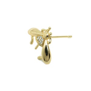 May include: Gold-toned bee earring with clear crystal accents. The earring has a post back.
