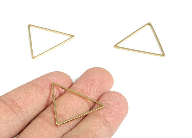 May include: Three gold triangle shaped metal hoops. The hoops are approximately 2.5 cm in diameter.