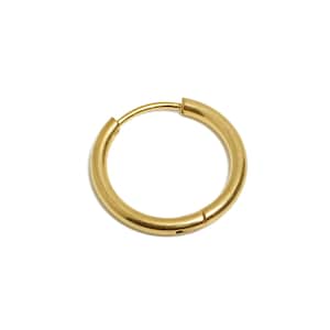 May include: A single gold-coloured hoop earring. The earring is circular, with a smooth, polished surface. The clasp is visible, indicating it is designed to be easily opened and closed. The earring is set against a plain white background.