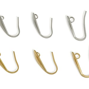May include: Six earring hooks in silver and gold. The hooks have a curved design with a loop at the top for attaching to an earring post. The hooks are made of metal and are displayed on a white background.