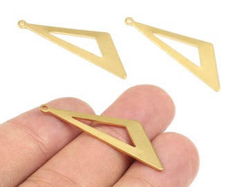 May include: Three gold-colored geometric charms. Two charms are positioned at the top, and one is held in a hand at the bottom. Each charm has a diamond shape with a smaller diamond cut out in the center. The charms have a small hole at the top.