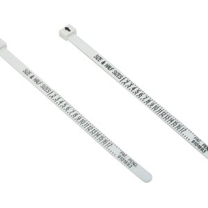 May include: Two white ring sizers with black text indicating sizes 1-17 and half sizes. Each sizer has an arrow at one end and the text "SIZE & HALF SIZES" printed on it. The text "PAT. PEND. 9101693" is also printed.