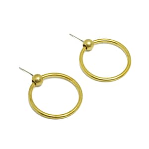May include: A pair of gold hoop earrings with a small ball at the top of each hoop.