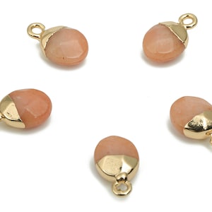 May include: Five gold-toned metal charms with a peach-colored stone. Each charm has a loop for attaching to a necklace or bracelet.