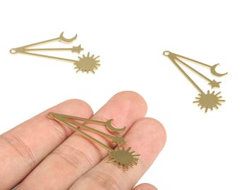 May include: Gold-colored celestial charms featuring a sun, star, and crescent moon design. These charms are ideal for jewelry making or crafting projects. The charms are shown in a close-up view.