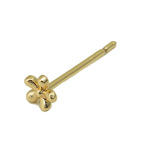May include: A gold flower-shaped nose stud with a straight post.