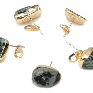 May include: Four pairs of gold-toned earrings with black and white speckled stone accents.