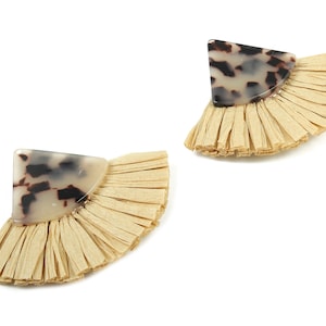 May include: A pair of fan-shaped earrings. Each earring has a light brown, fringed base and a triangular section of marbled, off-white and brown material. The earrings are displayed against a white background.
