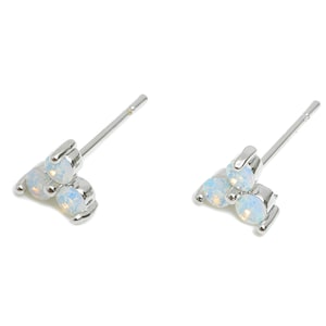 May include: A pair of silver stud earrings with three white opal stones each.