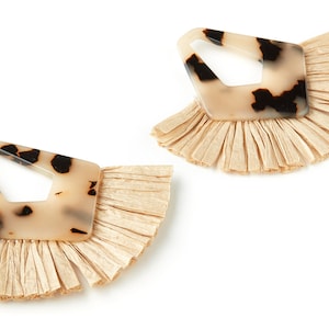 May include: A pair of earrings with a tortoiseshell-patterned, geometric, plastic design and a fringe of beige raffia.