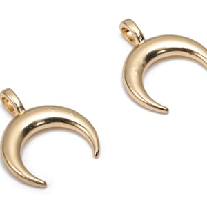 May include: Two gold crescent moon charms with a loop for attaching to jewellery.