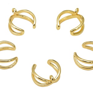 May include: Five gold-toned double-layered ear cuffs. Each cuff is a simple, open circle with a smooth finish.