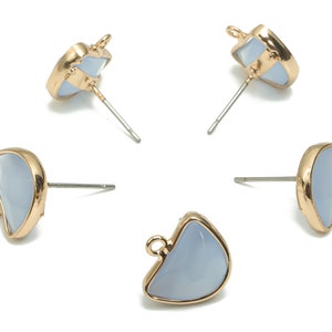 May include: Four gold-tone earrings with a light blue, semi-circular shaped stone. The earrings have a post back.
