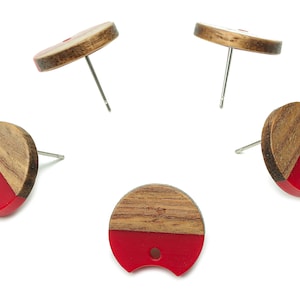 May include: Four pairs of red and brown wood earrings. Each earring is a half circle with a red bottom and a brown wood top. The earrings are attached to silver posts.