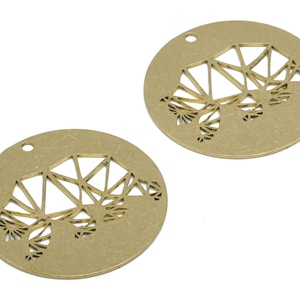 May include: Two gold-colored metal charms in the shape of a circle with a geometric animal design cut out.