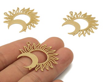 May include: Three gold-colored sun and moon charms. Each charm features a sun with radiating rays and a crescent moon. The charms are made of metal and have a small loop at the top for attaching to jewelry.