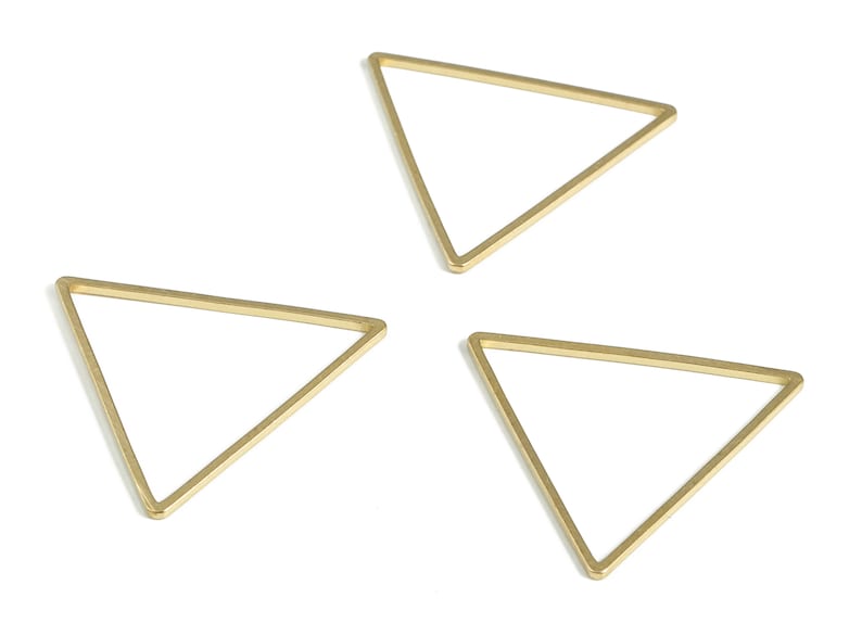 May include: Three gold-coloured metal triangle shapes.