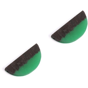 May include: Two half-circle shaped resin pendants with a black wood inlay and a green resin fill.