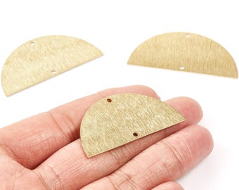 May include: Three brass-coloured, half-circle shaped metal jewellery components. Each piece has a textured surface and two small holes for attaching to other elements. The components are displayed against a white background.