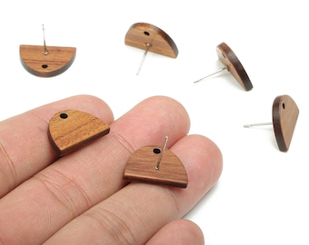 May include: Wooden stud earrings in various shapes, including half-circle and teardrop designs. The earrings are a warm brown color with silver-colored posts. The earrings are displayed on a white background.