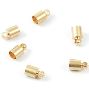 May include: Six gold-toned metal end caps with a small ball on the end. The end caps are designed to be used on cords or chains.