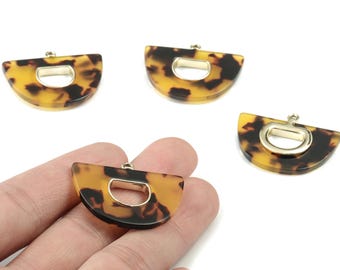 May include: Four tortoise shell-patterned pendants with gold-colored metal accents. Each pendant is a semi-circle shape with a rectangular cutout in the center. The pendants are likely for jewelry making or crafting.