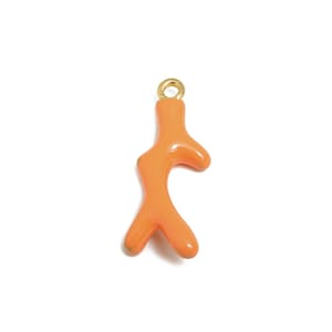 May include: A gold-toned charm shaped like a coral branch with a peachy orange color.