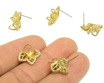 May include: Gold-colored floral earring posts with intricate petal designs. Some posts feature clear, sparkling accents. The earrings are shown in various angles, showcasing their delicate craftsmanship and potential for jewelry making.