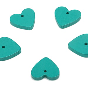 May include: Five teal wooden heart-shaped buttons with a hole in the centre of each.