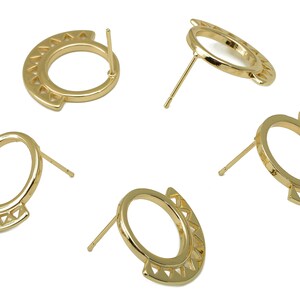 May include: Four gold-tone earring studs with a geometric design. Each earring features a circular shape with a cutout pattern of triangles around the edge.