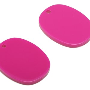 May include: Two bright pink oval-shaped plastic keyrings with a small hole at the top.