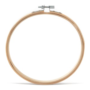 May include: A wooden embroidery hoop with a metal tightening screw. The hoop is round and has a natural wood finish.