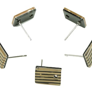 May include: Five pairs of gold and black striped rectangular earrings with silver posts.