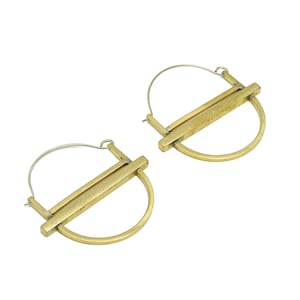 May include: A pair of gold hoop earrings with a geometric design. The hoops are made of a thick metal and have a bar across the center.
