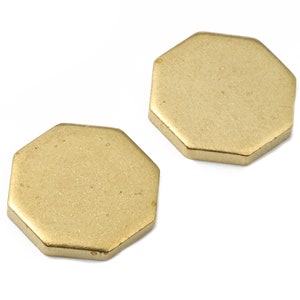 May include: Two gold-colored octagonal metal shapes.