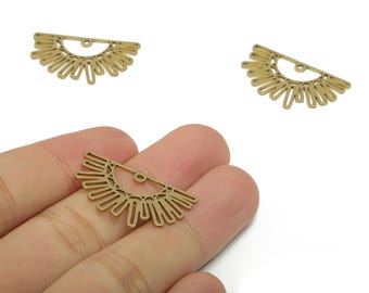 May include: Three brass-colored sunburst charms. One charm is held in a hand, while two others are scattered on a white background. The charms have a half-circle shape with a detailed sun ray design, perfect for jewelry making.