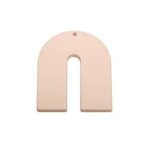 May include: A light peach-colored, arch-shaped pendant with a hole at the top for hanging. The pendant has a rounded top and two parallel, rectangular legs, creating a U-shape. The design is minimalist and modern.