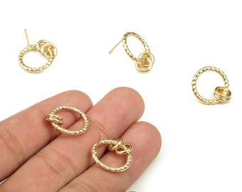 May include: Gold-colored earrings with a textured, twisted rope design. The earrings feature a circular or oval shape with a smaller, connected loop. Some are studs, while others are loose.
