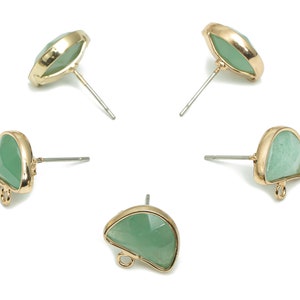 May include: Four pairs of gold-tone earrings with green gemstone accents. Each earring features a unique shape and a small loop at the bottom.